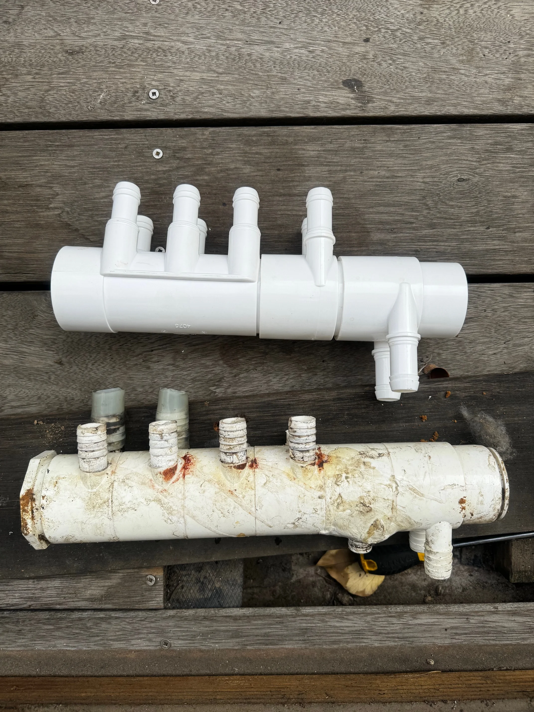 Old and replacement pool plumbing manifolds